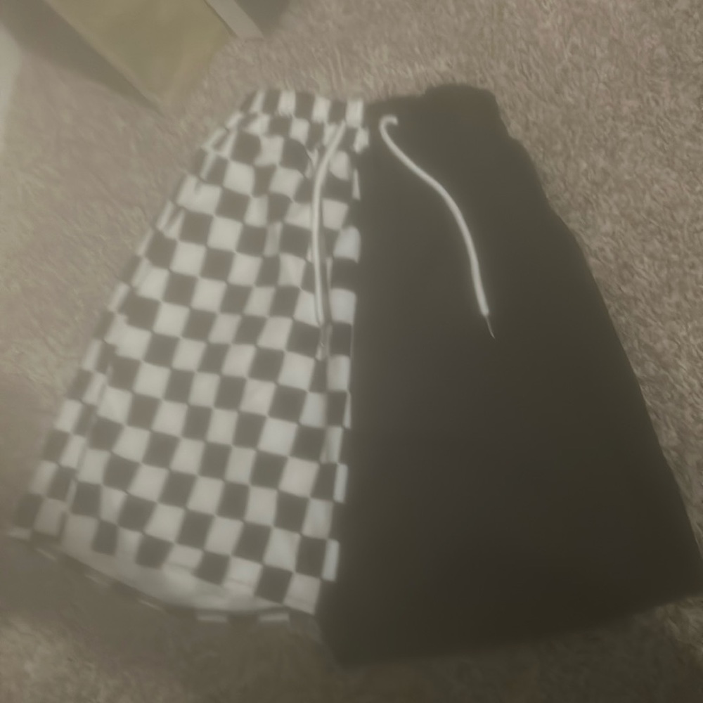 Checkers board and black split shorts